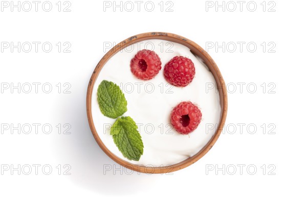 Yogurt with raspberry in clay cup isolated on white background. top view, flat lay, close up