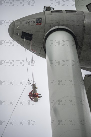 Height rescuers from the Oberhausen professional fire brigade practise abseiling from a wind turbine from a height of 150 metres, rescuing an injured person, technician, from the nacelle, Issum, North Rhine-Westphalia, Germany, Europe