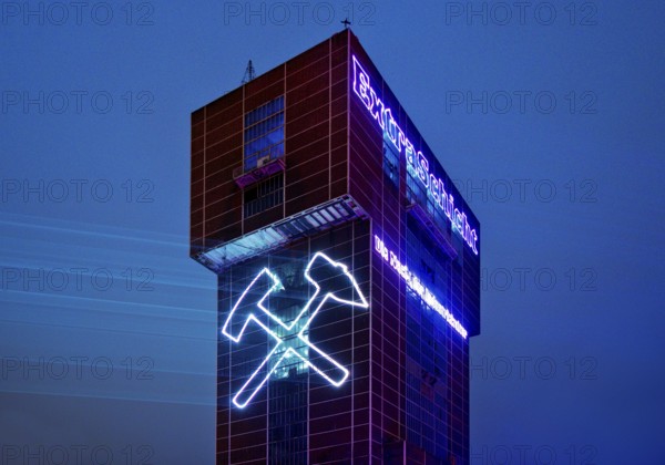 Illuminated hammerhead tower of Heinrich Robert colliery for the Extra Shift, Ost colliery, Hamm, Ruhr area, North Rhine-Westphalia, Germany, Europe