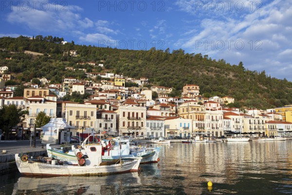 Small fishing boats in the Mediterranean harbour of Gythio or Gythion, behind houses and the Taygetos Mountains, Mani Peloponnese, Greece, Europe