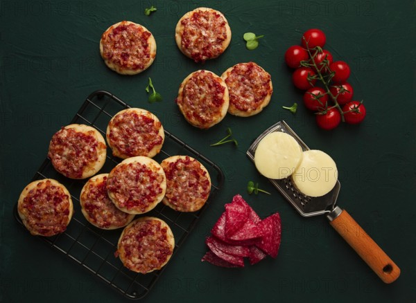 Mini pizzas, salami with mozzarella cheese, on the table, top view, no people