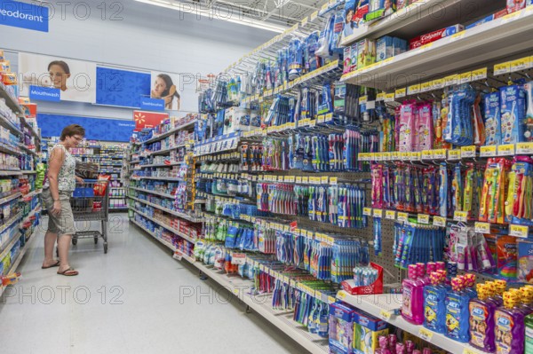 Woman shopping on oral hygiene isle at Walmart shopping center in Biloxi, Mississippi, USA, North America