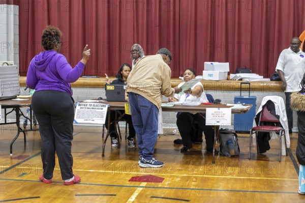 Detroit, Michigan USA, 5 November 2024, A voter gets his ballot for the 2024 presidential election shortly after the polls opened at Bethany Lutheran Church