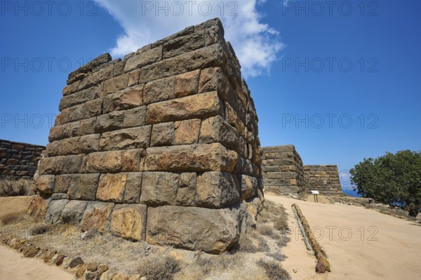 Ancient ruined wall in a dry landscape under a clear blue sky, Palaiokastro, Ancient fortress, 3rd and 4th century BC, above Mandraki, Nisyros, Dodecanese, Greek Islands, Greece, Europe