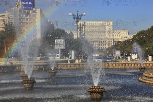 City centre, fountains and skyscrapers at Bulevardul Unirii, behind the Palace of Parliament, Bucharest, Romania, Europe