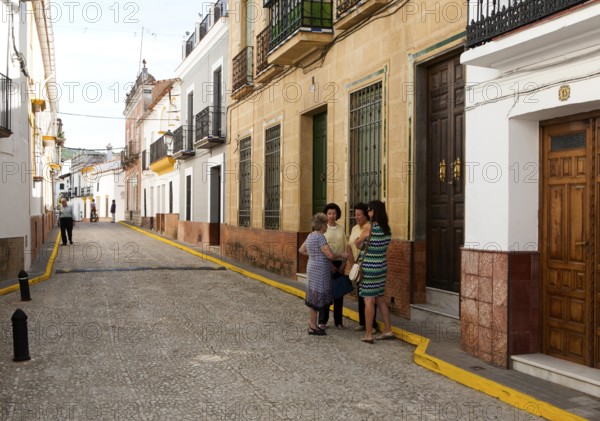 Group of women talking in the street, village of Alajar, Sierra de Aracena, Huelva province, Spain, Europe