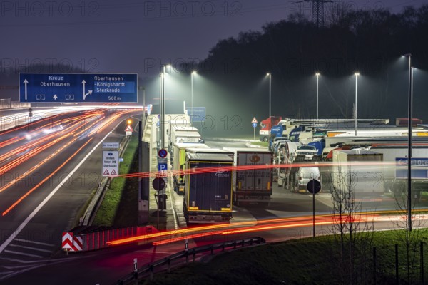 Heavy traffic on the A2 at the Schwarze Heide rest area, Bottrop, overcrowded car park for trucks in the evening, Bottrop, North Rhine-Westphalia, Germany, Europe