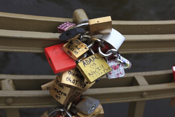 Lover's lock on a railing, love lock is a padlock which, according to custom, is attached to bridges by lovers to symbolically seal their eternal love, Prague, Czech Republic, Europe