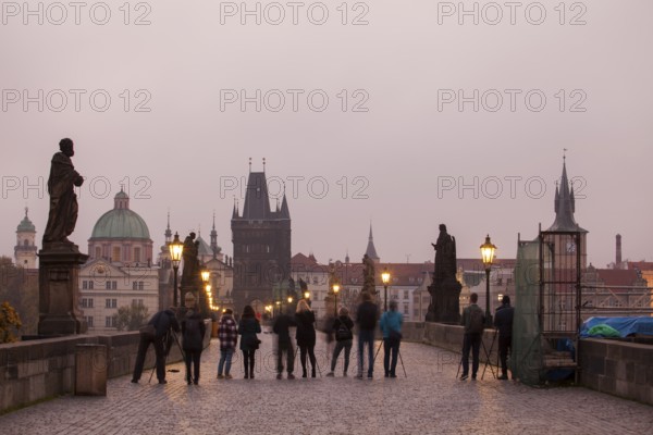 Photographers with tripod and camera on the Charles Bridge in Prague