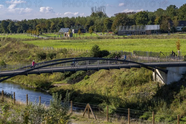 Bridge over the renaturalised Emscher in Emscherland, a new nature and water adventure park at the water crossing of the Emscher with the Rhine-Herne Canal, with lots of nature and recreational areas and information centres on the Emscher conversion and regional nature, North Rhine-Westphalia, Germany, Europe