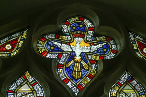 Detail of stained glass window by Charles Eamer Kempe, church of Saint Botolph, Burgh, Suffolk, England, UK c 1902 Holy Ghost dove