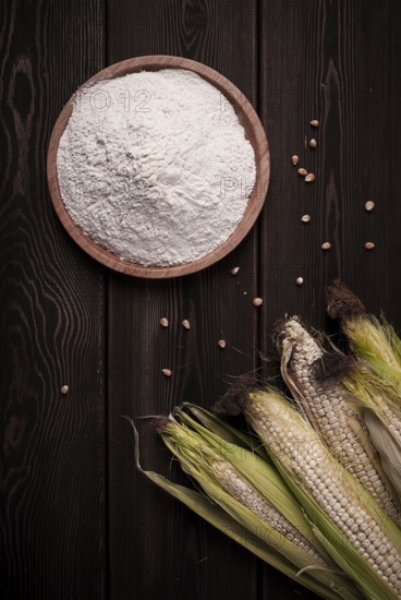 Corn cobs, corn flour, on a wooden table, top view, close-up, rustic, selective focus, dairy corn