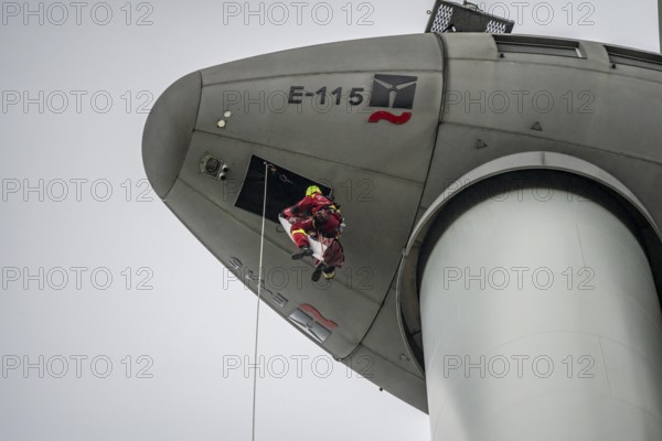 Height rescuers from the Oberhausen professional fire brigade practise abseiling from a wind turbine from a height of 150 metres, rescuing an injured person, technician, from the nacelle, Issum, North Rhine-Westphalia, Germany, Europe