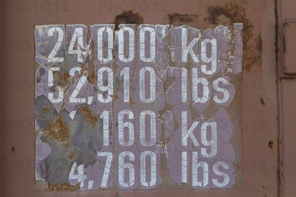 Close-up of maximum cargo cubic weight holding capacity indicated in kilograms and pounds on outside of shipping container, Quebec, Canada, North America