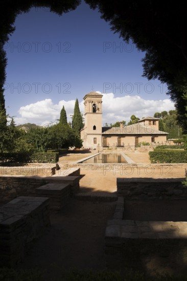 Ornamental garden with mirror water basin and a tower on the Alhambra palace grounds, Granada, Spain, Europe