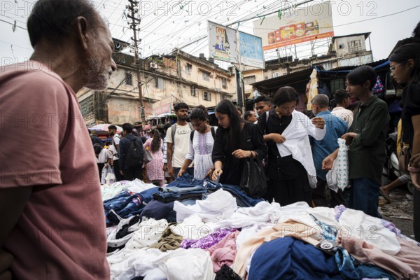 People buys clothes at a street market ahead of Durga Puja festival on October 7, 2024 in Guwahati, India. Shopping ahead of Durga Puja is a major event, as people prepare for the celebration