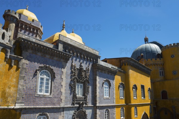 Part of a castle with yellow and grey facades, a dome and windows under a blue sky, Palácio Nacional da Pena, Pena National Palace, Sintra, Lisbon, World Heritage Site, UNESCO, Portugal, Europe