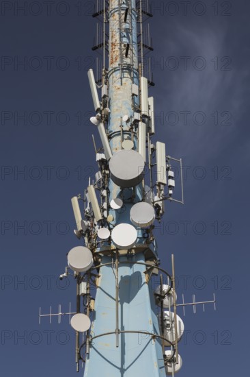 Mobile phone communications tower with antennas against blue sky, Mount Srd, Dubrovnik, Croatia, Europe