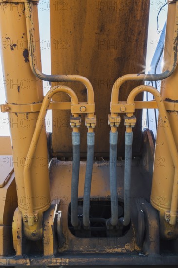 Electrical power and hydraulic fluid supply lines on heavy duty backhoe excavator, Quebec, Canada, North America