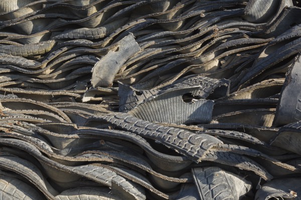 Pile of assorted shredded black rubber motor vehicle tires in recycling yard, Quebec, Canada, North America