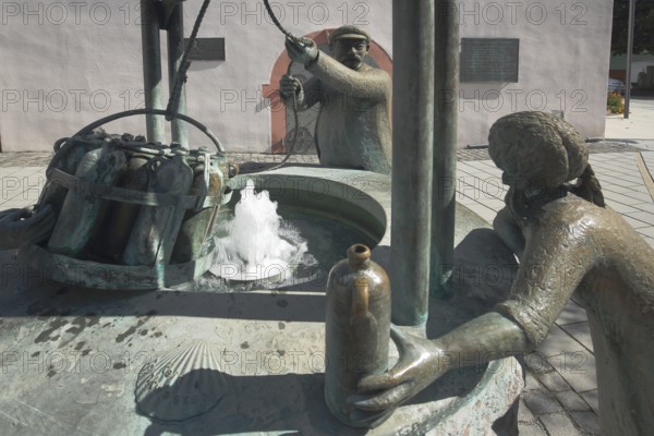 Drawing fountain from 1999 with sculptures and monument to mineral water town history, water, historical, bronze, male figure, draw, pull up, transport, rope, basket, crate with water bottles, bottles, Old Town Hall, Market Square, Bad Vilbel, Wetterau, Hesse, Germany, Europe