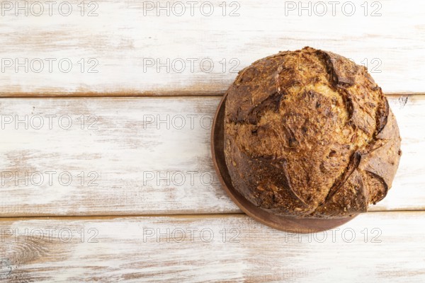 Fresh homemade golden grain bread with wheat and rye on white wooden background. top view, flat lay, copy space