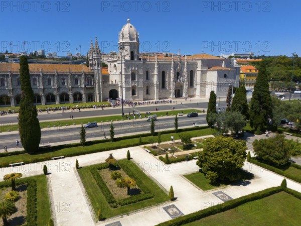 Gothic church with surrounding gardens and green areas next to a street under a clear blue sky, aerial view, Hieronymus Monastery, Mosteiro dos Jerónimos, Hieronymite Monastery, World Heritage Site, Monastery Church of Santa Maria, Belém, Belem, Bethlehem, Lisbon, Lisboa, Portugal, Europe