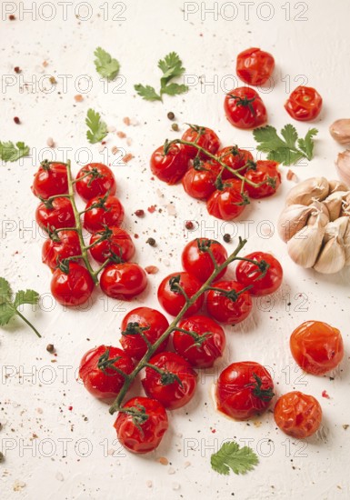 Baked branch, mini, cherry tomatoes, with spices and herbs, garlic, food background, top view, on a white background