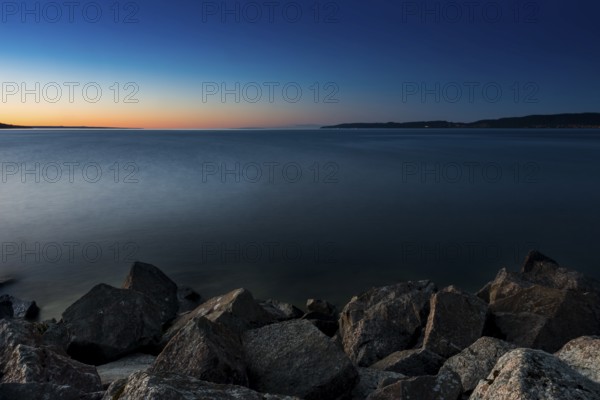 Lake Vättern in the evening light, lake, water, inland waters, inland lake, calm, evening light, sunset, evening sun, long exposure, emotion, romantic, mood, romance, stone, shore, silence, melancholy, nature, blue hour, fresh water, climate, Jönköping, Sweden, Scandinavia, Europe