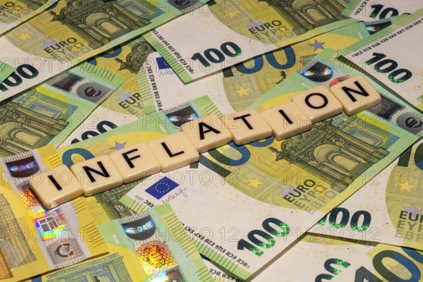 Symbolic image of inflation: letters on euro notes show the word inflation