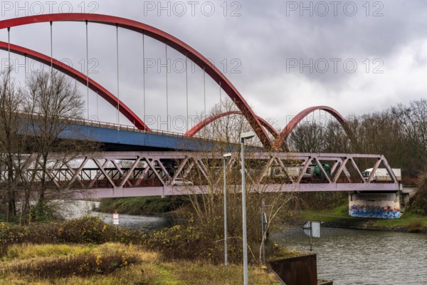 Dilapidated A42 motorway bridge (red arches) over the Rhine-Herne Canal, with massive structural damage, totally closed for the next few months, between the Bottrop-Süd and Essen-Nord junctions, probably for HGVs until a new bridge is built, North Rhine-Westphalia, Germany, Europe