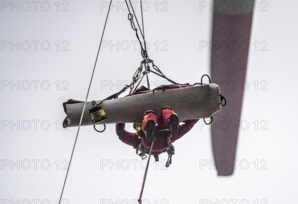 Height rescuers from the Oberhausen professional fire brigade practise abseiling from a wind turbine from a height of 150 metres, rescuing an injured person, technician, from the nacelle, Issum, North Rhine-Westphalia, Germany, Europe