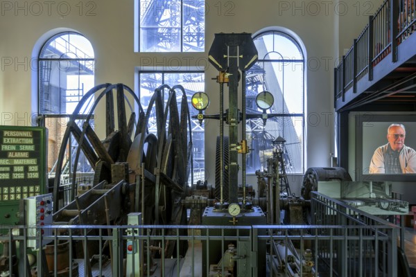 Winding engine with depth indicator to raise and lower lift cage in mine shaft at Le Bois du Cazier coal mine museum, Marcinelle, Hainaut, Belgium, Europe