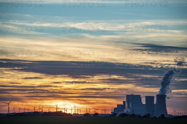 The RWE lignite-fired power plant Neurath, near Grevenbroich, largest German coal-fired power plant, second largest in Europe, Block F-G, wind farm, sunset, North Rhine-Westphalia, Germany, Europe