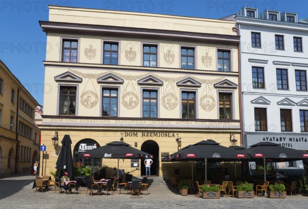 Historic facades with art and street cafés under a blue sky, Klonowica tenement house, Old Town, Lublin, Poland, Europe