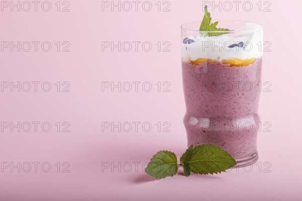 Smoothie with honeysuckle, linen and chia in a glass on pink pastel background. side view, close up, copy space