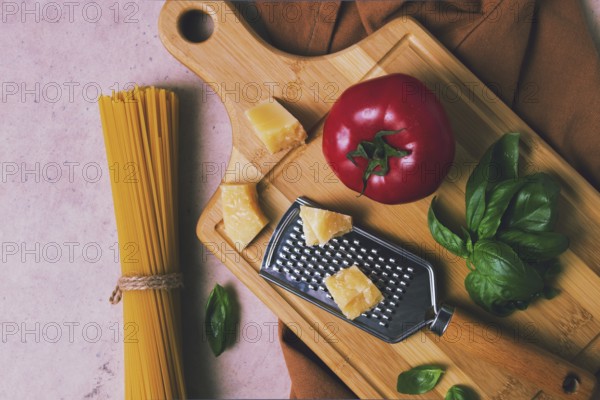 Raw pasta with ingredients on a beige background, top view, rustic style, selective focus, no people