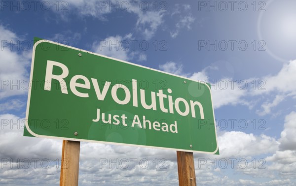 Revolution just ahead green road sign over clouds and blue sky, AI generated