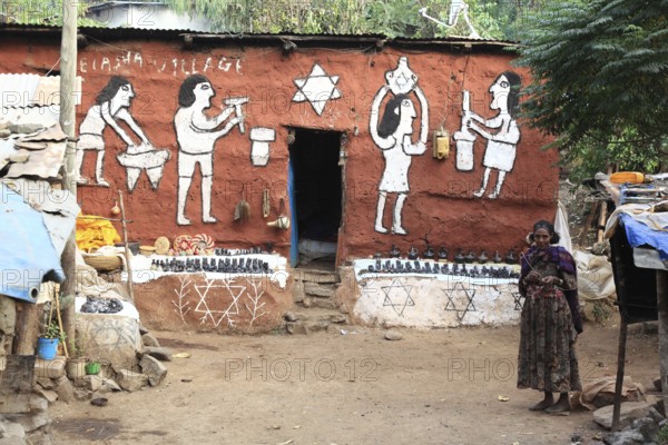 Amhara region, in the Falasha village of Wolleka near Gondar, Gonder, Jewish village, woman selling home-made souvenirs, painted house, Ethiopia, Africa