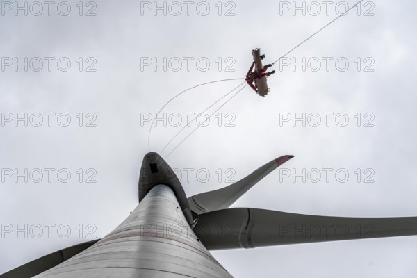 Height rescuers from the Oberhausen professional fire brigade practise abseiling from a wind turbine from a height of 150 metres, rescuing an injured person, technician, from the nacelle, Issum, North Rhine-Westphalia, Germany, Europe