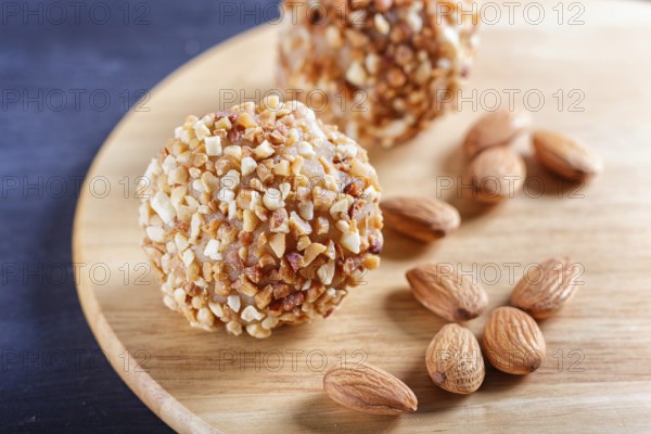 Energy balls cakes with almonds on wooden board on black background. selective focus, close up