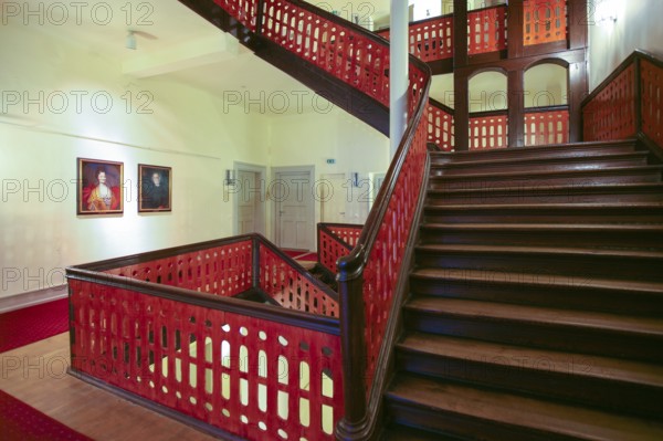 Moated castle Oppenweiler, interior, staircase, wooden stairs, handrail, banister, built in the 18th century, classicist style, today town hall, architecture, hallway, red carpet, runner, paintings, oil paintings, portraits, portraits, Oppenweiler, Rems-Murr-Kreis, Baden-Württemberg, Germany, Europe