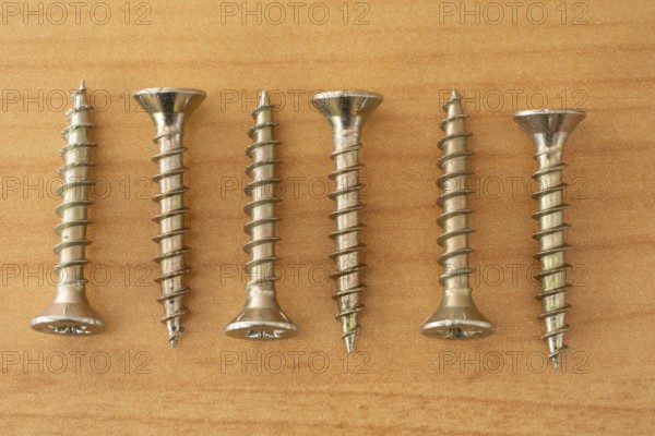 Phillips screws on wooden background, wood screws, spax screws