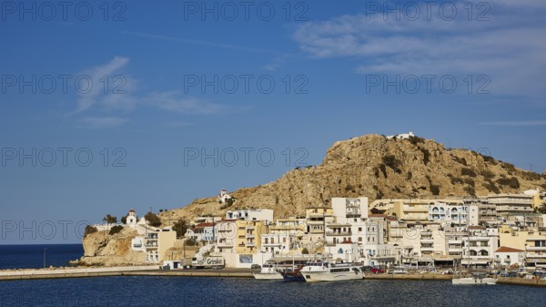 Coastal town with white houses and boats in the harbour, surrounded by hills under a clear blue sky, Pigadia, town and harbour, Pigadia Bay, main town, Karpathos, Dodecanese, Greek Islands, Greece, Europe