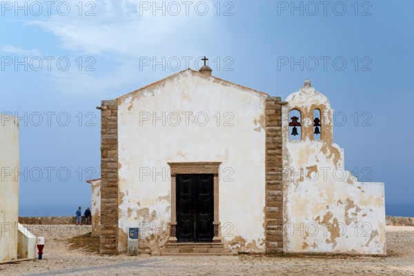 A historic chapel with bell tower and views of the ocean, surrounded by ancient walls, Igreja de Nossa Senhora da Graça, Church of Our Lady of Grace, Fortaleza de Sagres, Sagres sea fortress, Ponta de Sagres, Sagres, Faro, Algarve, Portugal, Europe