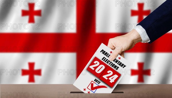 Georgian parliamentary elections. Hand holding ballot in voting ballot box with Georgian flag in background