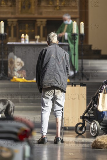 A mentally confused homeless man in the church, family mass with blessing of animals in St Agnes, Agneskirche, Cologne, North Rhine-Westphalia, Germany, Europe