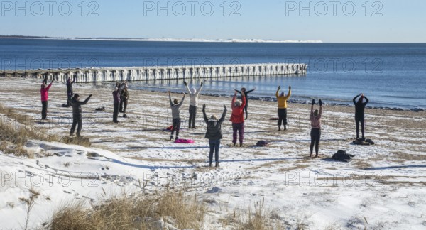 Group of exercisers in winter on the beach in Ystad, Skåne County, Sweden, Baltic Sea, Scandinavia, Europe