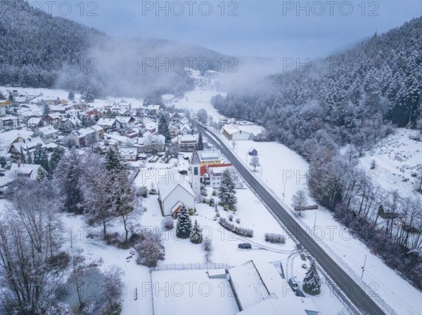 Snow-covered village with a main street, embedded in a hilly landscape, Enzklösterle, district of Calw, Black Forest, Germany, Europe