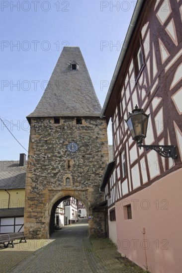 Historic clock tower and landmark, town gate, town tower, street lamp, Herrstein, Hunsrück, Rhineland-Palatinate, Germany, Europe